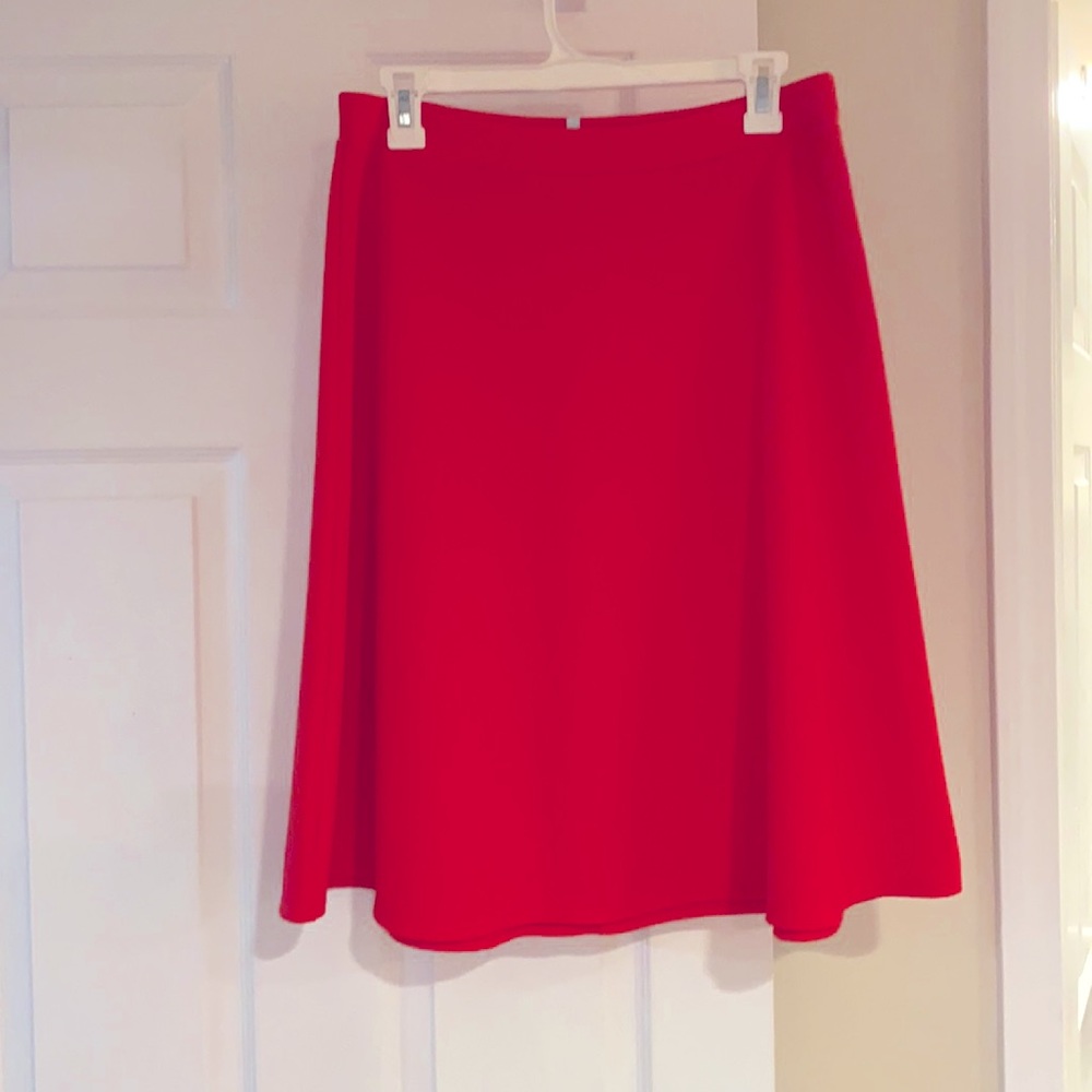 Comfy coral colored skirt, machine wash, length 23”